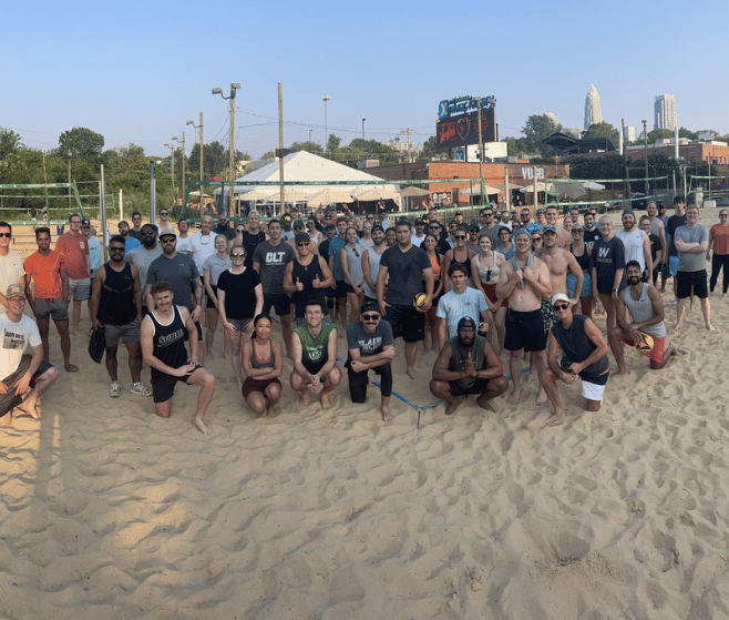 group of sand volleyball players in charlotte